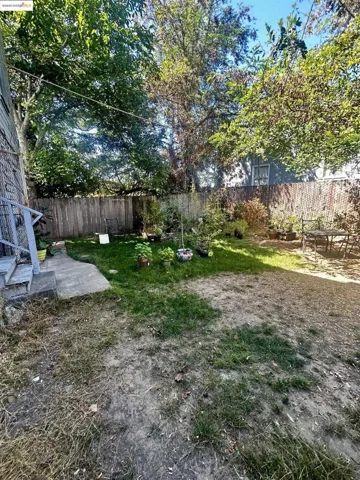 Fenced backyard with a patio area