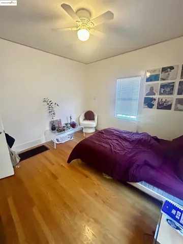 Bedroom featuring wood finished floors and a ceiling fan