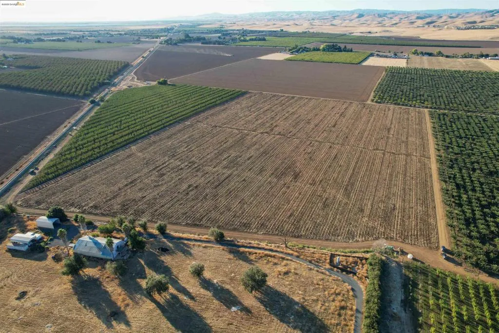 Aerial overview of property's location featuring rural landscape and large plots for crops