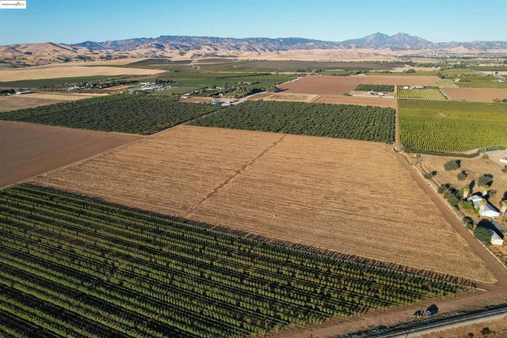 View of rural area with farmland and a mountain backdrop