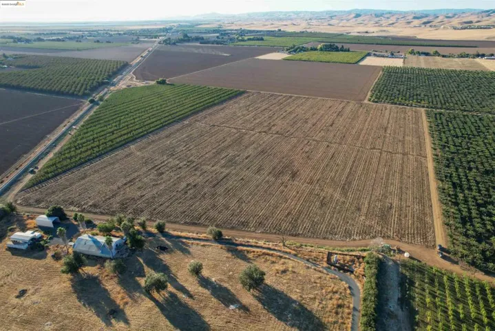 Aerial overview of property's location featuring rural landscape and large plots for crops