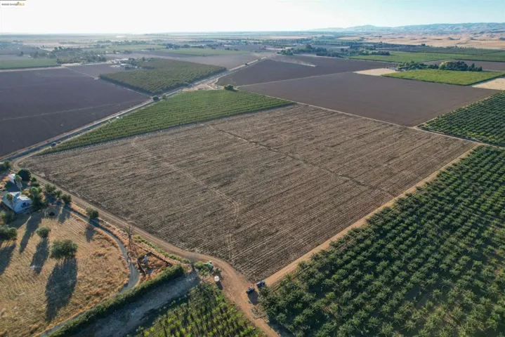 Overview of rural landscape featuring large plots for crops