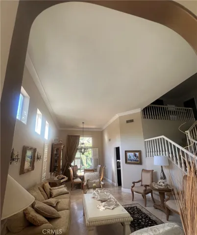 two high ceiling living rooms