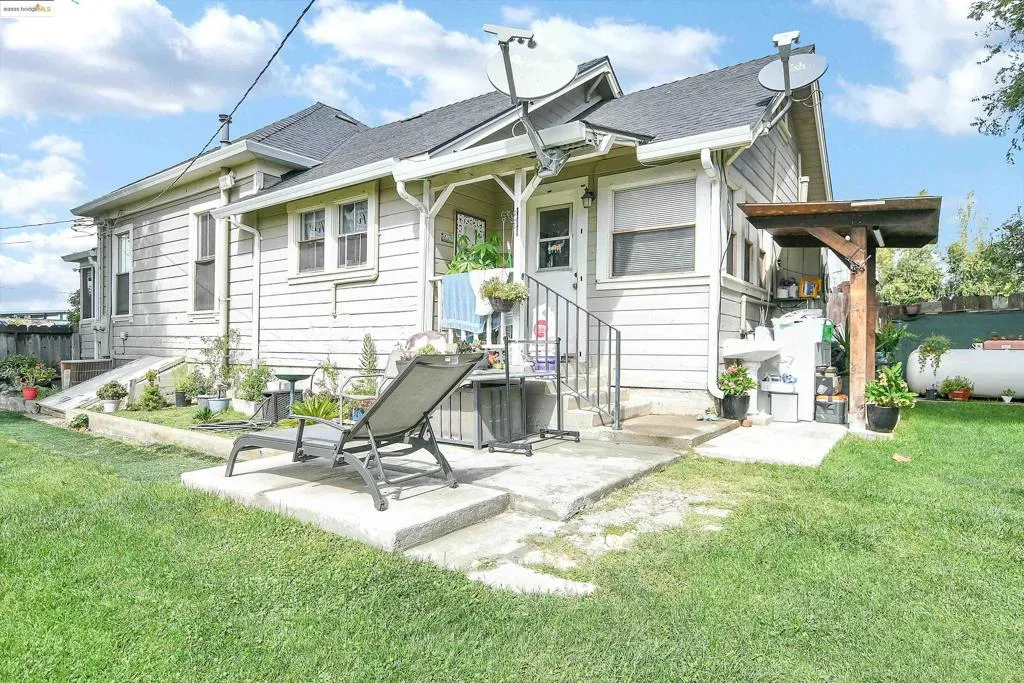 Rear view of house with a shingled roof