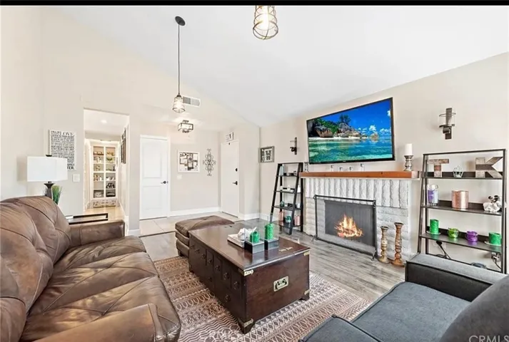 Family room leads to front door and kitchen area and hallway.