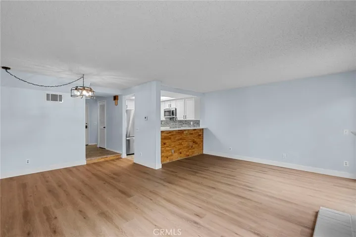 Living room, Dining area, Kitchen and level 1 hallway in view