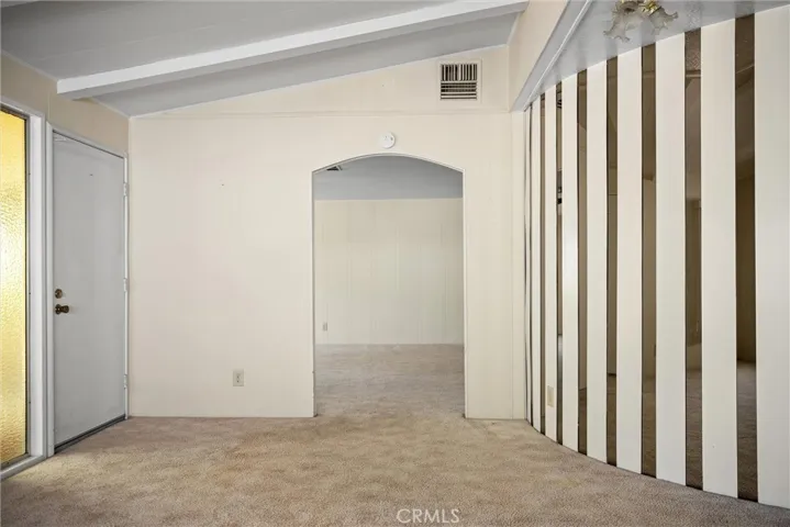 front door living room and arch leads to family room