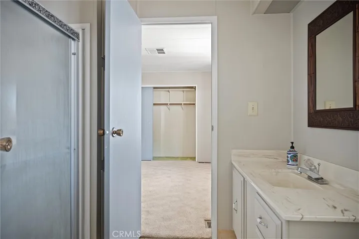 guest bath that accessible from laundry space and opens to bedroom 2