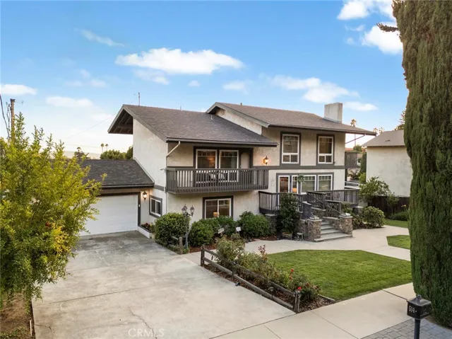 A 2 car garage with room to park multiple cars in the driveway.
