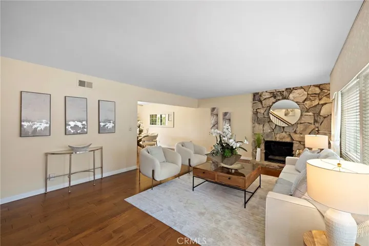 Formal living room has wood floors.