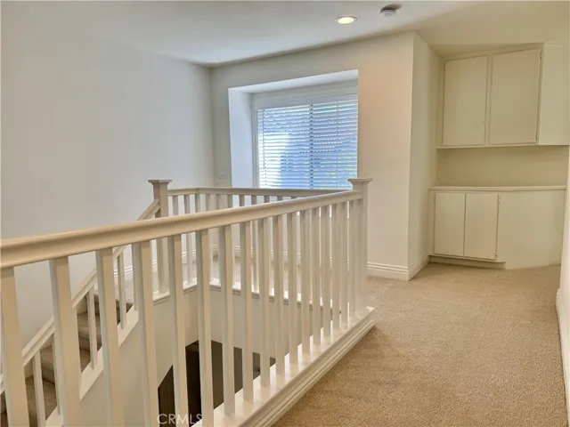 Open landing and hallway with primary bedroom at opposite end from guest bedrooms