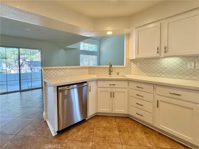 Custom backsplash and white quartz countertops