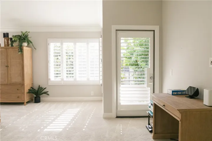 primary bedroom with office knock and balcony