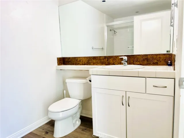 Secondary bathroom with extended mirror and storage.