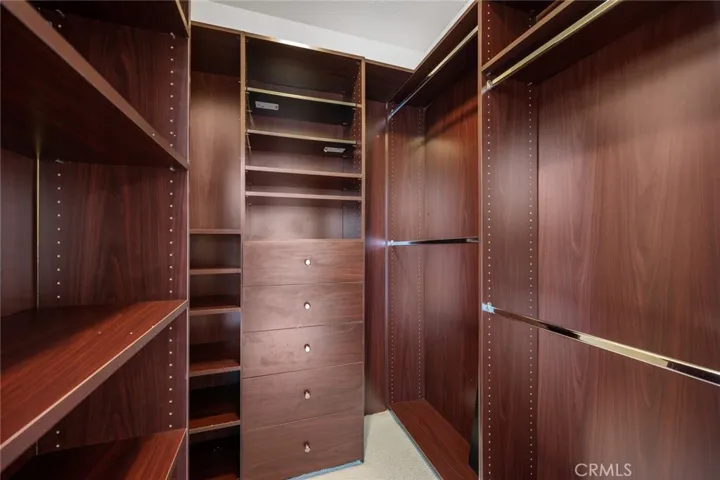 Custom built-in shelving in primary walk-in closet