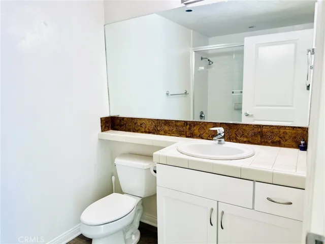 Secondary bathroom featuring vanity and mirror lighting.
