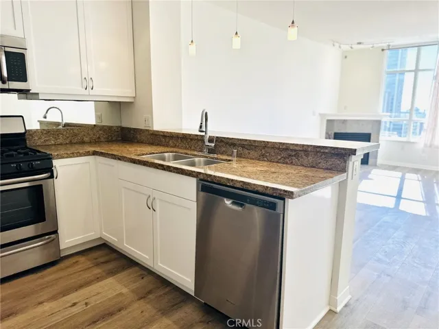 Open kitchen with breakfast bar and direct access to the living space.