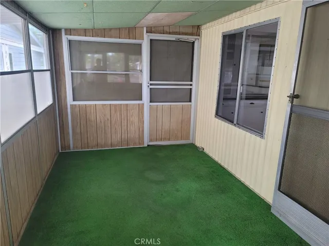 Enclosed sun room just a stip away from living room.