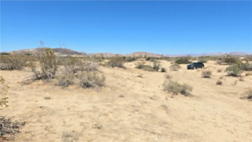 Shot from SE corner of property looking NW. The auto is at the NE corner.