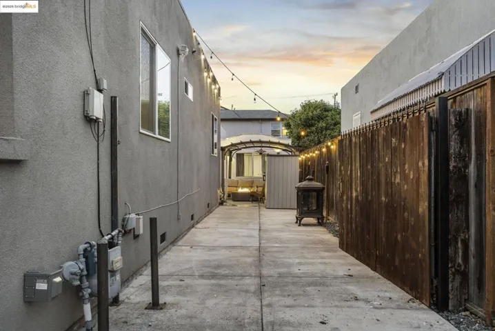 View of property exterior, driveway with EV charging station. Long driveway that leads to backyard