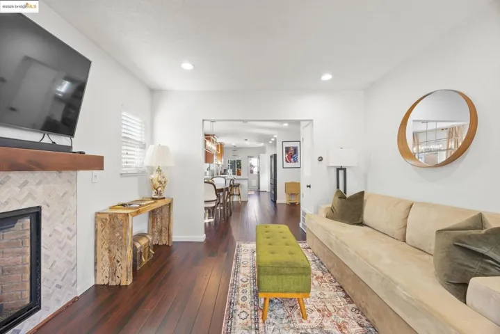 Living area featuring a tile fireplace, dark wood-type flooring, and recessed lighting