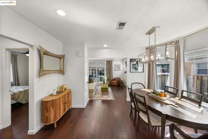 Dining space featuring a chandelier, dark wood-style floors, recessed lighting, and plenty of natural light