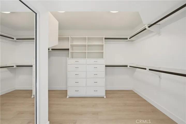 Custom walk-in closet in primary bathroom