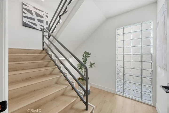 Ascend the stairs from the 1st floor to the main living 2nd level and 3rd level primary wing