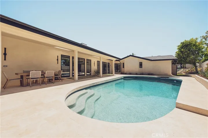Resort like backyard with travertine grounds