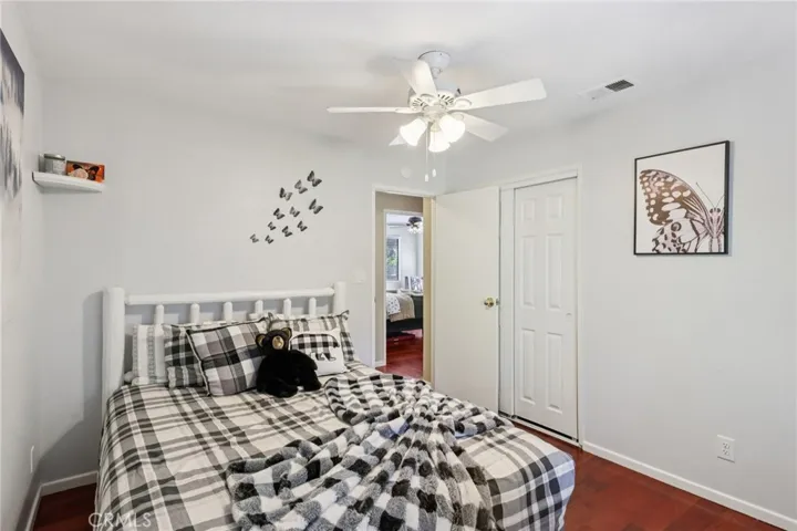 Guest bedroom alternate view showing closet and clean, neutral finishes.