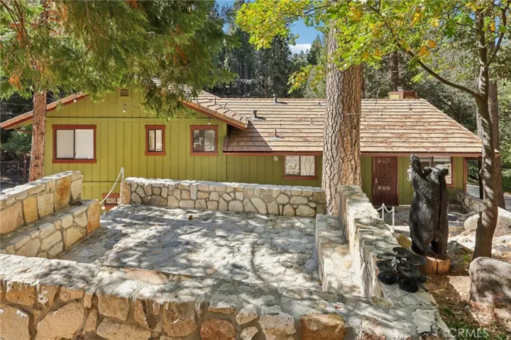 Entertaining platform with stone walls and whimsical bear carving.