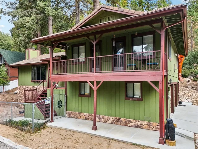 Front elevation highlight with full-length covered deck and fenced side entry