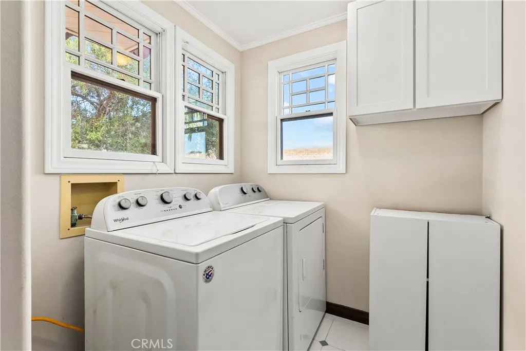 Separate Laundry Room with Large Capacity Washer and Dryer Plus Storage