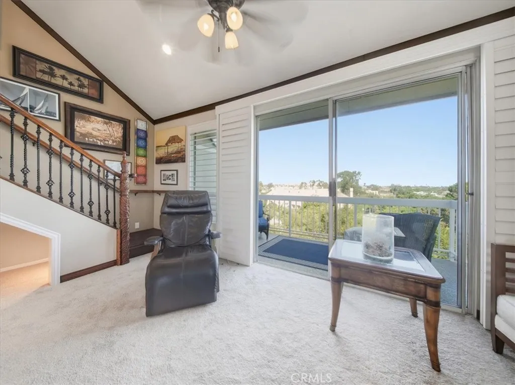 Penthouse living area with sliding glass doors, plantation shutters, and breathtaking vista views stretching for miles