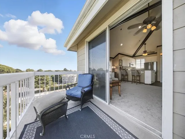 South-facing penthouse with panoramic views of Huntington Beach and Newport Coast. Inside, enjoy vaulted ceilings, elegant wood beams with decorative trim, and a sunlit living area that seamlessly blends indoor comfort with coastal vistas.