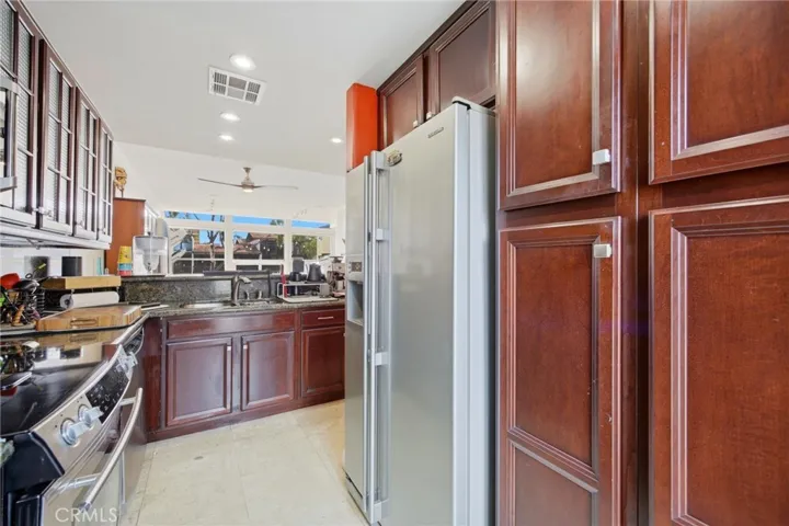 Beautifully remodeled gourmet kitchen with custom cabinets and exquisite marble counters!