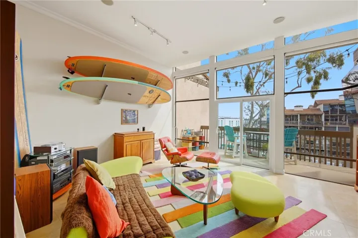 Spacious living room with wall to wall floor to ceiling windows, gas fireplace and a private balcony overlooking the picturesque marina!