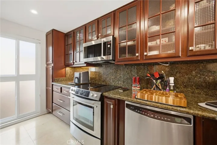 Beautifully remodeled gourmet kitchen with custom cabinets and exquisite marble counters!