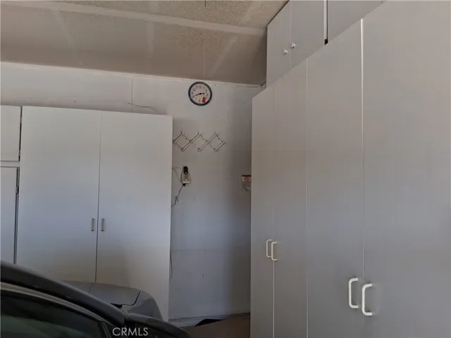 storage cabinet along the side wall of garage.