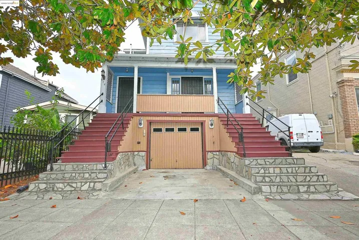 View of front of house featuring stairway, a garage, and concrete driveway