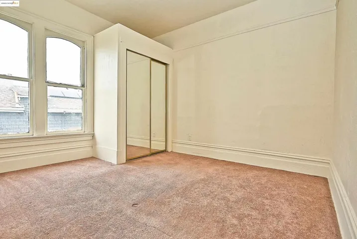 Unfurnished bedroom featuring carpet and a closet