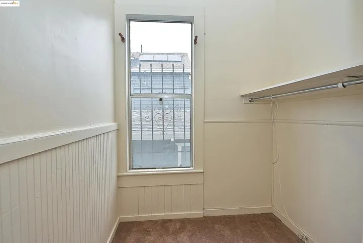 Walk in closet featuring dark carpet