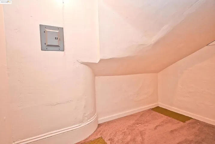 Detailed view of carpet floors and electric panel