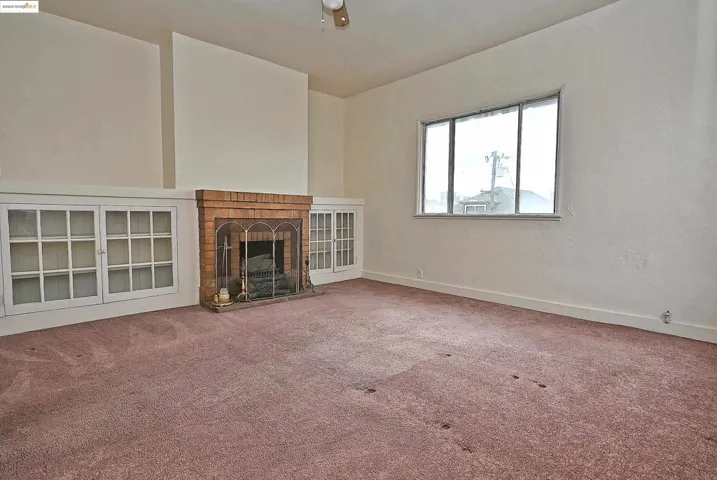 Unfurnished living room with a fireplace and carpet