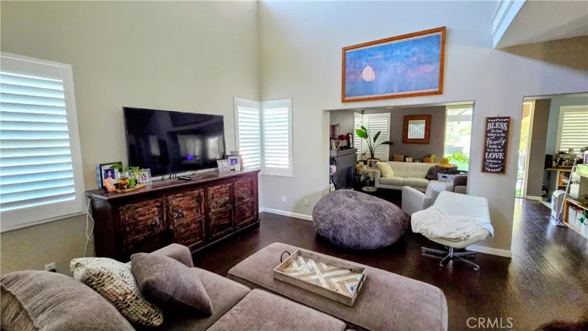View of the living room into the family room and kitchen. Come and take a tour of 10 Verano, Foothill Ranch.