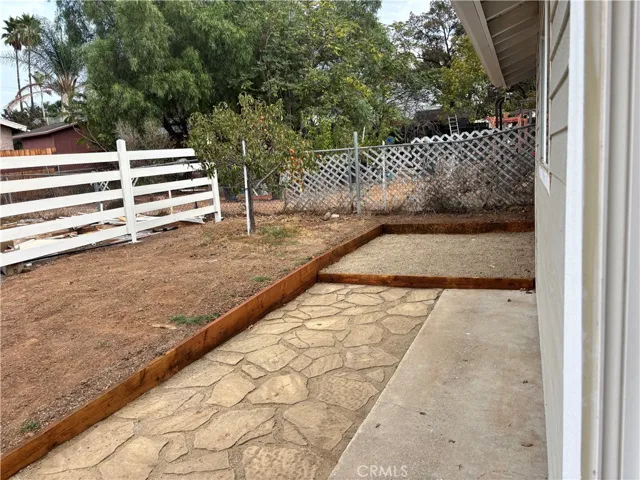 Side yard with peach tree.