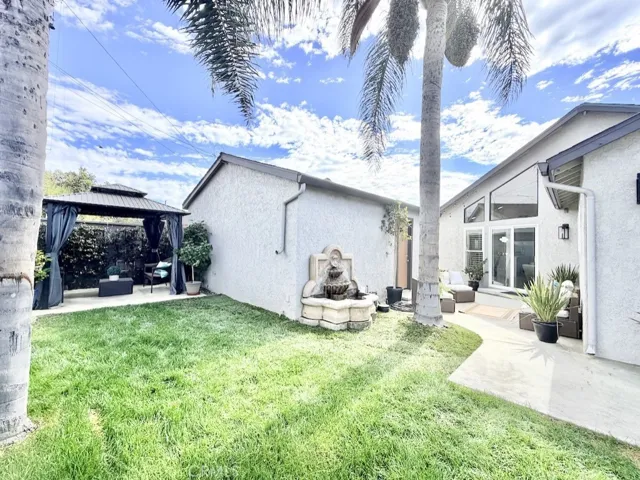 Lush grassy backyard with exotic palms