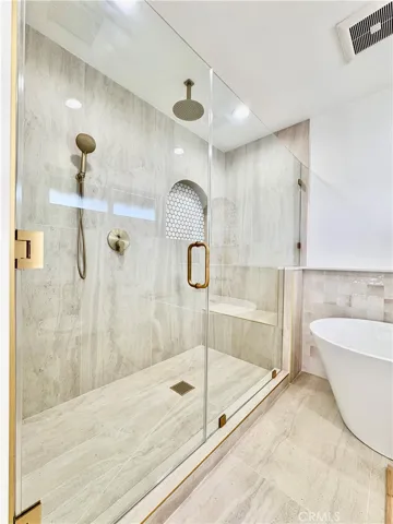 Oversized shower with shaving seat