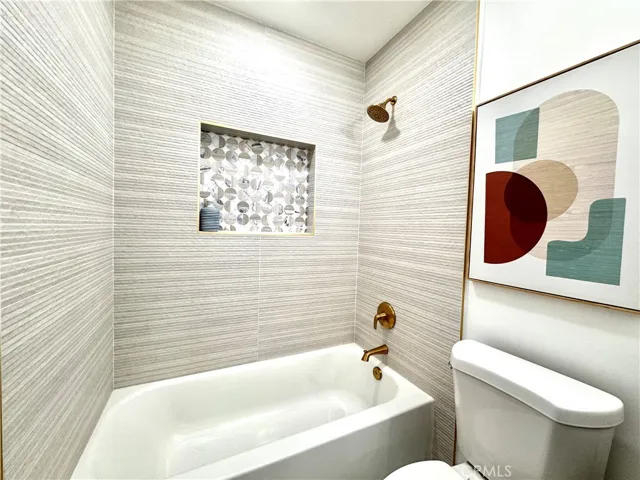 Hot-out-of-the-kiln designer bath surround with marble tile highlights