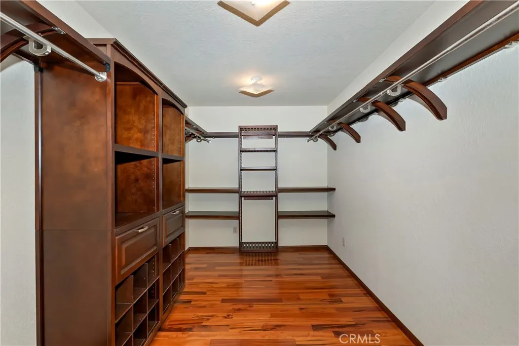 Walk in 7x12 foot closet with custom built cabinets.